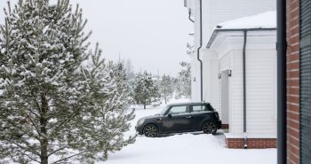 Snow-covered driveway in winter, cleared with an electric snow blower