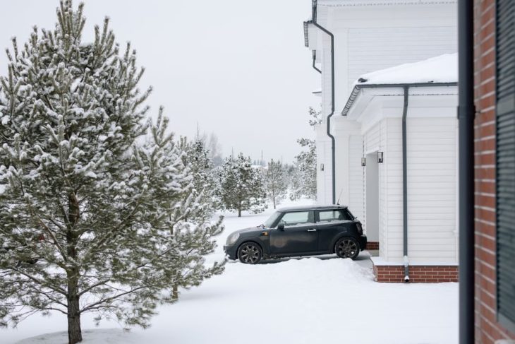 Snow-covered driveway in winter, cleared with an electric snow blower