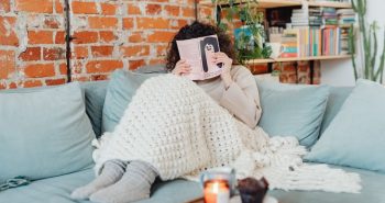 Cozy blanket on a bed on a winter evening