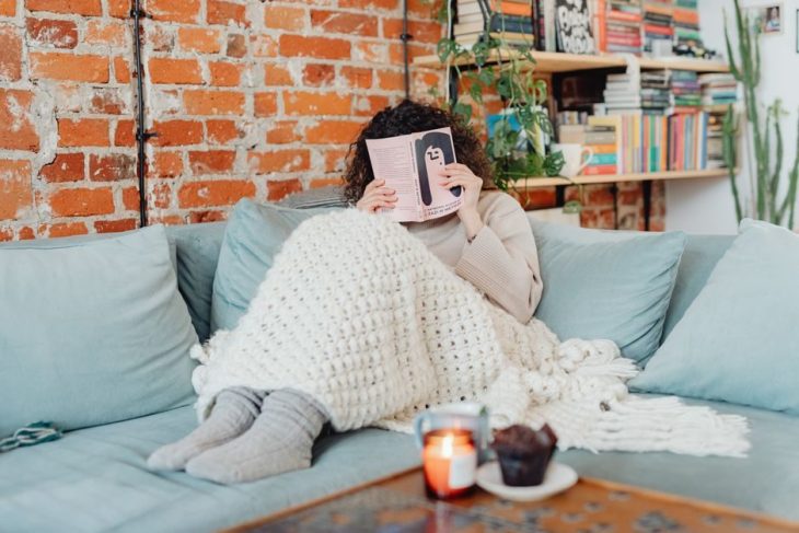 Cozy blanket on a bed on a winter evening