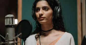 Singer recording vocals at a studio microphone