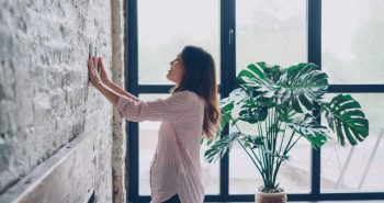 Smart thermostat on a living room wall