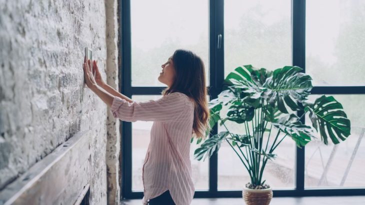 Smart thermostat on a living room wall