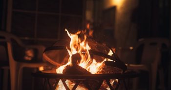 Smokeless fire pit burning in a backyard at night