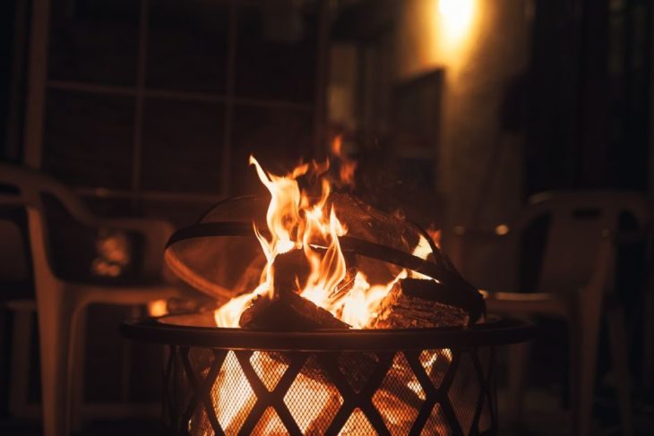 Smokeless fire pit burning in a backyard at night