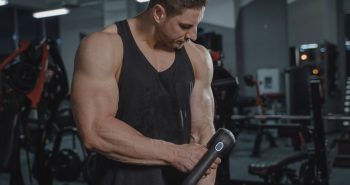 Athlete using a massage gun after a workout