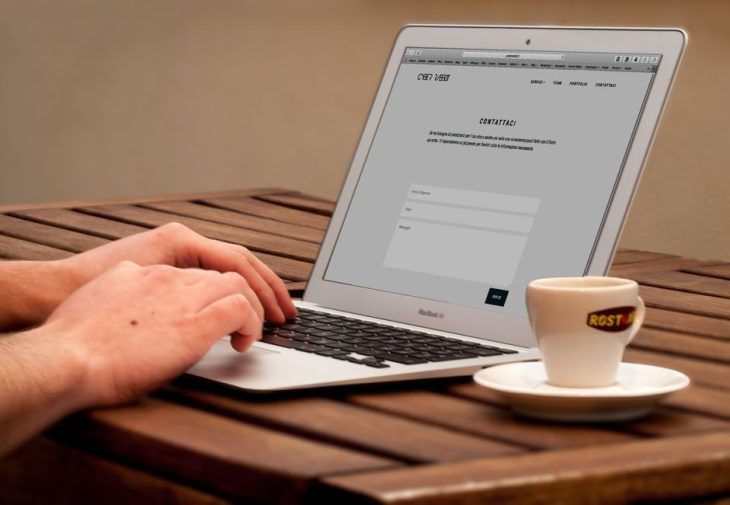 Designer building a website on a laptop